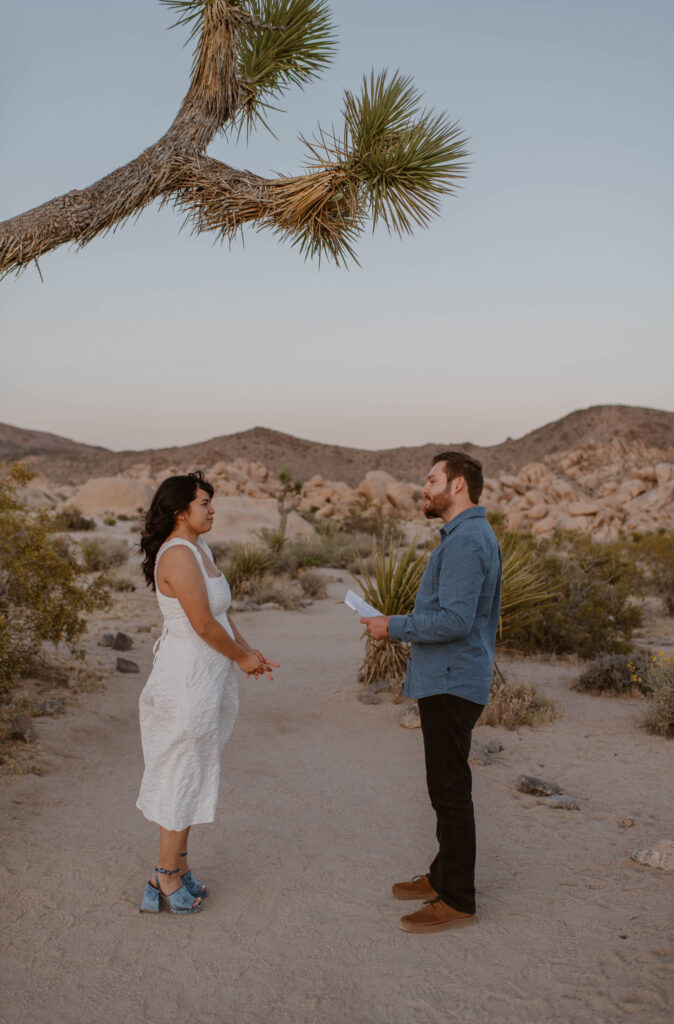“Couple exchanging vows at sunset in Joshua Tree National Park”
“Intimate desert vow reading at golden hour”