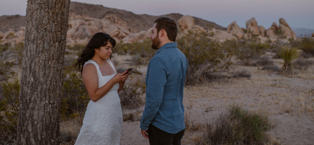 “Couple exchanging vows at sunset in Joshua Tree National Park”
“Intimate desert vow reading at golden hour”