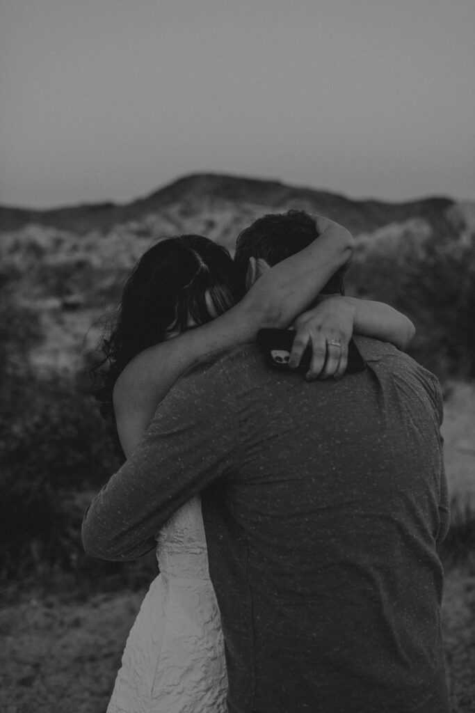 “Couple exchanging vows at sunset in Joshua Tree National Park”
“Intimate desert vow reading at golden hour”